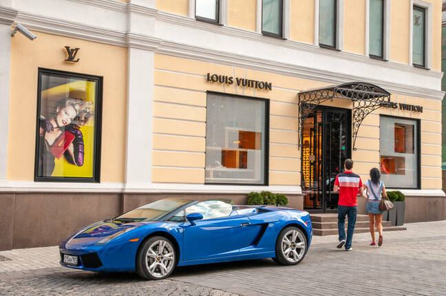 A young couple shop at Louis Vuitton in Moscow's Stoleshnikov Pereulok, one of the most expensive boutique shopping areas in the world